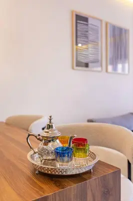 a tea set on a glass tray on a table at Luxury Apartment Gueliz, Cinema Bedroom Experience in Marrakech