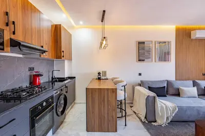 a kitchen and a living room with a couch at Luxury Apartment Gueliz, Cinema Bedroom Experience in Marrakech