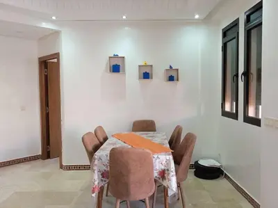 a dining room with a table and chairs at Appart Premium Village Marrakech in Marrakech