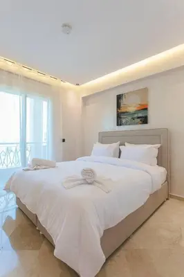a bedroom with a large white bed with a bow on it at Luxury Odyssey - Marrakech Centre in Marrakech