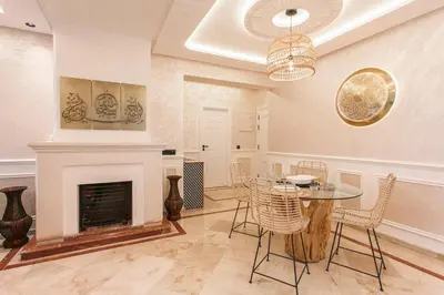 a dining room with a table and a fireplace at Luxury Odyssey - Marrakech Centre in Marrakech