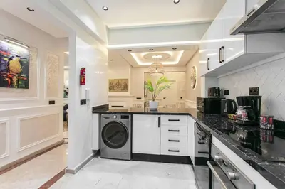a kitchen with a washer and dryer in it at Luxury Odyssey - Marrakech Centre in Marrakech