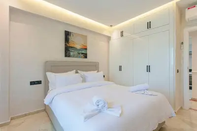 a bedroom with a white bed with a bow on it at Luxury Odyssey - Marrakech Centre in Marrakech