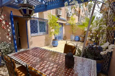 a patio with a table and chairs in a courtyard at Appartement Guéliz Centre Marrakech in Marrakech