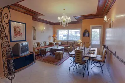 a living room with a table and a dining room at Appartement Guéliz Centre Marrakech in Marrakech