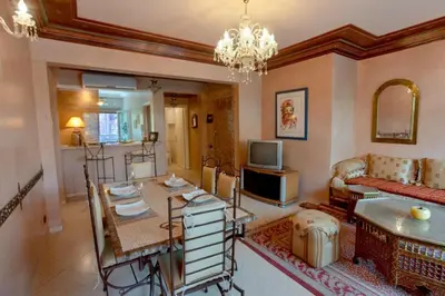 a living room with a couch and a television at Appartement Guéliz Centre Marrakech in Marrakech