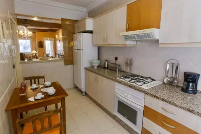 a kitchen with a refrigerator and a table in it at Appartement Guéliz Centre Marrakech in Marrakech