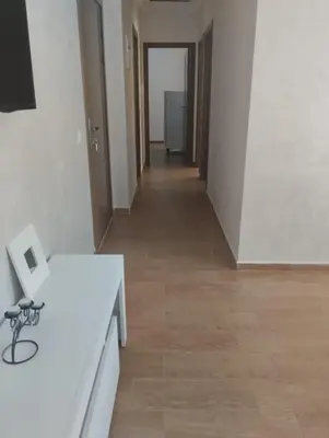 a hallway with white walls and a wooden floor at Chill Apartment Portes Gueliz in Marrakech
