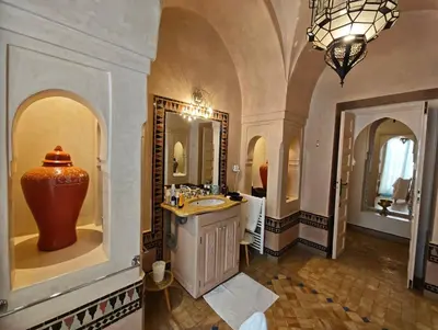 a bathroom with a sink and a large vase on the wall at Marrakech, villa 7 Harmonia, pour 6 personnes avec piscine privée in Marrakech