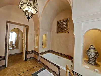 a large bathroom with a tub and a chandelier at Marrakech, villa 7 Harmonia, pour 6 personnes avec piscine privée in Marrakech