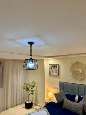 a room with a bed and a potted tree in it at The Cosy Duplex With Gym Access & Near Mall, Palooza in Marrakech