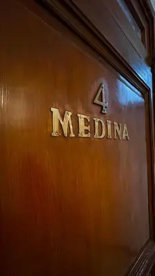 a wooden door with the word medina on it at Residence Koutoubienne in Marrakech
