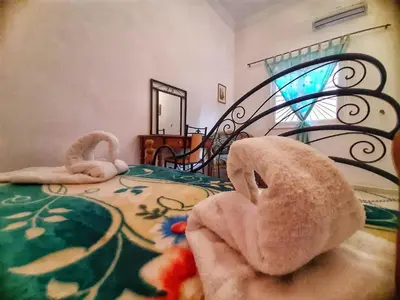 a bedroom with a stuffed animal laying on a bed at Residence Koutoubienne in Marrakech