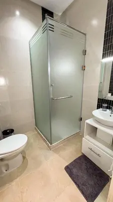 a bathroom with a shower with a toilet and a sink at Spacious Apartment 102m2 3 Bedrooms 2 Bathrooms 8 Guests Elevator Self Check in in Marrakech