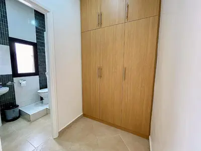 a bathroom with wooden cabinets and a toilet at Spacious Apartment 102m2 3 Bedrooms 2 Bathrooms 8 Guests Elevator Self Check in in Marrakech