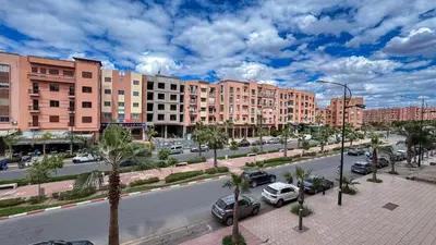 a city street with cars parked in front of buildings at Spacious Apartment 102m2 3 Bedrooms 2 Bathrooms 8 Guests Elevator Self Check in in Marrakech
