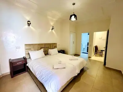 a bedroom with a large bed with two towels on it at Marrakech 2 Bedroom Family Apartment in Marrakech