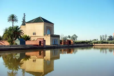 a building with its reflection in a body of water at Marrakech 2 Bedroom Family Apartment in Marrakech