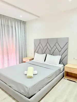 a bedroom with a large bed with two towels on it at Confortable & Spacieux & Au Centre-ville in Marrakech