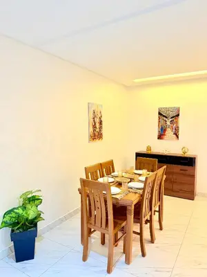 a dining room with a wooden table and chairs at Confortable & Spacieux & Au Centre-ville in Marrakech