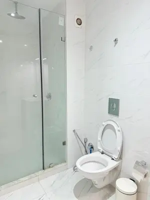 a bathroom with a toilet and a glass shower at Confortable & Spacieux & Au Centre-ville in Marrakech