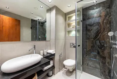 a bathroom with a shower and a sink and a toilet at Luxueux appartement prestigia golf/vue piscine in Marrakech
