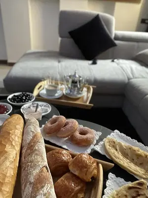 a table with various types of bread and pastries on it at Appartement de luxe à louer in Marrakech