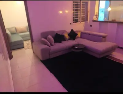 a purple living room with a couch and a table at Appartement de luxe à louer in Marrakech