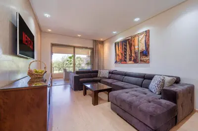 a living room with a couch and a table at Green Side Golf 3 B.R Apartment in Marrakech