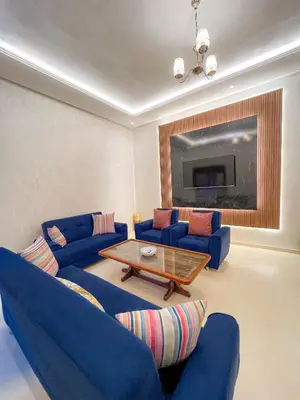 a living room with blue couches and a coffee table at Cozy apartment pool marrakech morocco in Marrakech