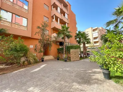 a building with a brick driveway in front of it at Cozy apartment pool marrakech morocco in Marrakech