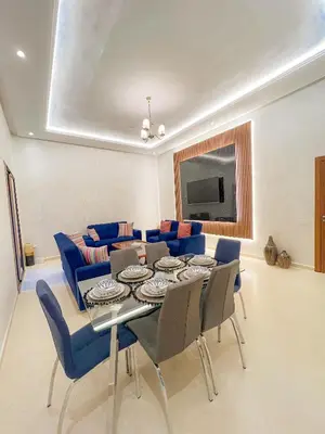 a living room with a table and blue chairs at Cozy apartment pool marrakech morocco in Marrakech