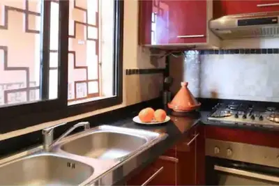 a kitchen with a sink and a stove and a window at Appart-Oasis/3 Piscines/2 Terrasses in Marrakech