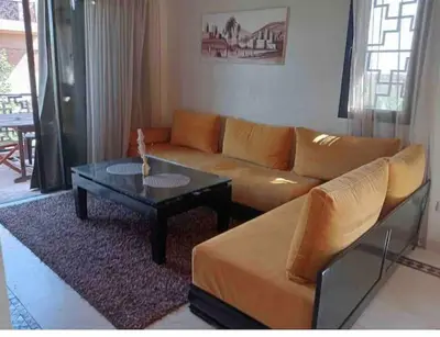 a living room with a couch and a coffee table at Appart-Oasis/3 Piscines/2 Terrasses in Marrakech