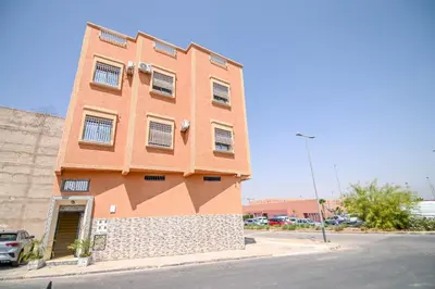 a large brick building on the side of a street at The Skyline Stay in Marrakech