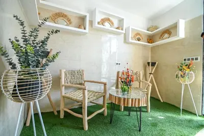 a room with two chairs and a table with flowers at The Skyline Stay in Marrakech