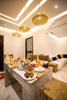 a dining room with a table with food on it at Marrakech Apartments in Marrakech