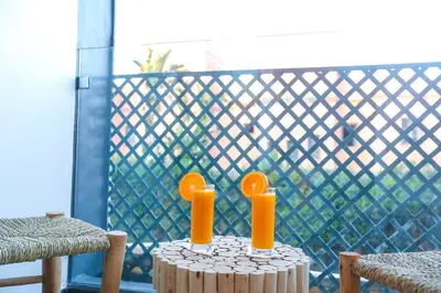 two orange candles on a table on a balcony at Marrakech Apartments in Marrakech
