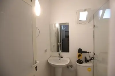 a white bathroom with a sink and a toilet at Marrakech Apartments in Marrakech