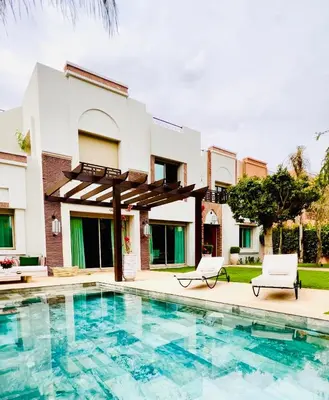 a villa with a swimming pool and a house at Villa Jenna in Marrakech