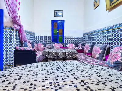 a living room with a couch and a table at Riad Sultana - 10 min à pied de Jemaa El Fna in Marrakech