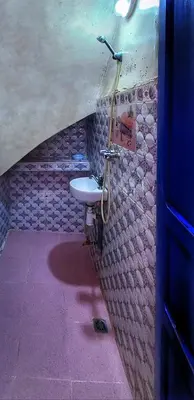 a bathroom with a sink on a wall at Riad Sultana - 10 min à pied de Jemaa El Fna in Marrakech