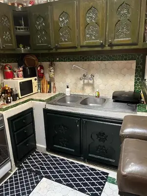 a kitchen with a sink and a microwave at Penthouse Jaccuzi Atlas Marrakech in Marrakech