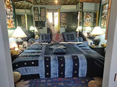a bedroom with a bed with a blue and white blanket at Penthouse Jaccuzi Atlas Marrakech in Marrakech