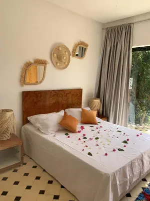 a bedroom with a bed with flowers on it at La villa Berbère - Famille uniquement in Marrakech