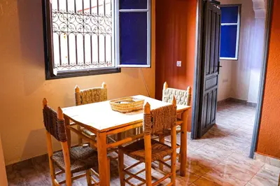 a dining room with a table and chairs and a window at Appartement MSholidays Gazelle Marrakech in Marrakech