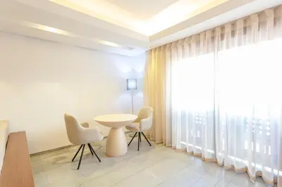 a room with a table and chairs and a large window at The Gallery Suite – Marrakech Centre in Marrakech