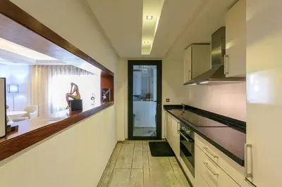 a kitchen with a counter and a person in the window at The Gallery Suite – Marrakech Centre in Marrakech