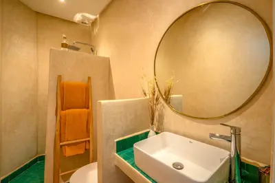 a bathroom with a sink and a mirror at Riad Bella Kasbah in Marrakech
