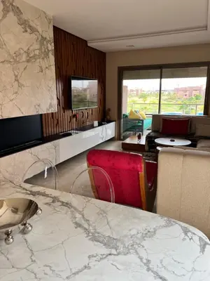 a living room with a large marble table and chairs at Prestigia Golf Vue Atlas et Piscine in Marrakech